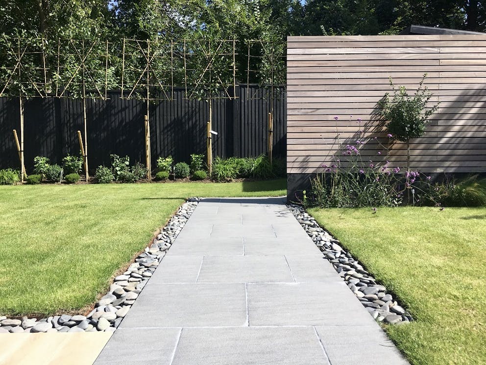 View of the completed garden landscape design showing the rear planting and patio.