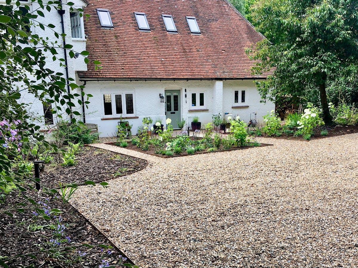 The completed clean, practical driveway and vegetable garden beds framing the front of the property.